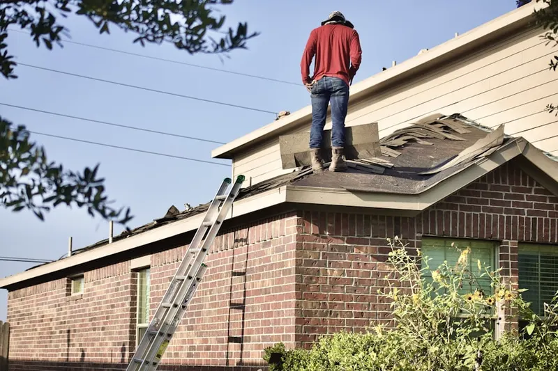Professional roofer working on a residential roof in Westbrooke